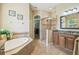 Bright bathroom featuring a soaking tub, glass-enclosed shower, and granite countertops at 32015 Summerglade Dr, Wesley Chapel, FL 33545