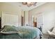 Bedroom with a view to the bathroom, closet, and double doors to hall at 32015 Summerglade Dr, Wesley Chapel, FL 33545