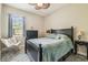 Inviting bedroom features a ceiling fan and cozy seating area at 32015 Summerglade Dr, Wesley Chapel, FL 33545