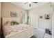 Charming bedroom featuring a flamingo-themed bedspread, white furnishings, and a comfortable area rug at 32015 Summerglade Dr, Wesley Chapel, FL 33545