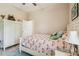 Comfortable bedroom with a flamingo-themed bedspread, neutral walls, and an adjacent doorway at 32015 Summerglade Dr, Wesley Chapel, FL 33545