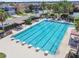 Large community pool surrounded by lounge chairs and palm trees in a well-maintained neighborhood at 32015 Summerglade Dr, Wesley Chapel, FL 33545
