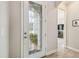 Front door with decorative glass and view to formal living room at 32015 Summerglade Dr, Wesley Chapel, FL 33545