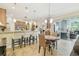 Bright kitchen features granite counters, bar seating, and an adjacent dining area at 32015 Summerglade Dr, Wesley Chapel, FL 33545