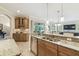 Open kitchen boasts granite countertops, stainless steel appliances, and light wood cabinets at 32015 Summerglade Dr, Wesley Chapel, FL 33545