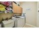 Functional laundry room with modern appliances, ample storage cabinets, and a convenient utility sink at 32015 Summerglade Dr, Wesley Chapel, FL 33545