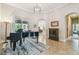Formal living room features a grand piano, tile floors and large windows at 32015 Summerglade Dr, Wesley Chapel, FL 33545