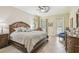 Main bedroom with tile floors, ceiling fan, and ensuite bathroom access at 32015 Summerglade Dr, Wesley Chapel, FL 33545