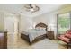 Bedroom with tile floors, ceiling fan, and lots of closet space at 32015 Summerglade Dr, Wesley Chapel, FL 33545