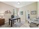 Bright home office featuring a modern desk and views to the bedroom at 32015 Summerglade Dr, Wesley Chapel, FL 33545