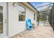 Enclosed patio with brick pavers and home's exterior, showcasing storage space and view of pool area at 32015 Summerglade Dr, Wesley Chapel, FL 33545