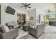Covered patio featuring comfortable seating around a gas fire pit and mounted television at 32015 Summerglade Dr, Wesley Chapel, FL 33545