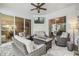 Spacious covered patio with comfortable seating, a fire pit, and a mounted television at 32015 Summerglade Dr, Wesley Chapel, FL 33545