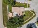 Aerial view of the property showing roof, backyard and detached covered carport with mature tree and landscaping at 3242 Brushwood Ct, Clearwater, FL 33761