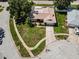 An aerial shot of a residential house highlighting its landscaped yard, driveway, and proximity to the street at 3242 Brushwood Ct, Clearwater, FL 33761