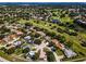 Aerial view of a neighborhood adjacent to a lush golf course and small ponds at 3242 Brushwood Ct, Clearwater, FL 33761