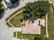Aerial view of a residential property showcasing the roof, backyard and carport surrounded by mature trees at 3242 Brushwood Ct, Clearwater, FL 33761