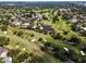 Panoramic aerial view of a sprawling golf course community with ponds and mature trees at 3242 Brushwood Ct, Clearwater, FL 33761