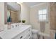 Bright bathroom featuring white vanity with marble countertop and shower with curtain at 3242 Brushwood Ct, Clearwater, FL 33761