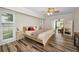 Primary bedroom boasts wood-look flooring, neutral walls, and generous natural light at 3242 Brushwood Ct, Clearwater, FL 33761