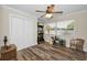 Bedroom featuring a ceiling fan, closet, and an arcade machine beside the window at 3242 Brushwood Ct, Clearwater, FL 33761