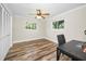 Bright bedroom featuring wood-look floors, windows and closet at 3242 Brushwood Ct, Clearwater, FL 33761
