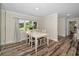 Bright dining room featuring modern wood-look floors and ample natural light at 3242 Brushwood Ct, Clearwater, FL 33761