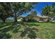 Charming home exterior with well-kept lawn, mature trees, and neatly trimmed landscaping at 3242 Brushwood Ct, Clearwater, FL 33761