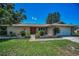 Beautiful single-story home with a well-manicured lawn, quaint landscaping, and attached two car garage at 3242 Brushwood Ct, Clearwater, FL 33761