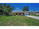 Charming single-story home with a well-maintained lawn and a neatly landscaped front yard at 3242 Brushwood Ct, Clearwater, FL 33761