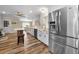 Modern eat-in kitchen with stainless steel appliances, white cabinets, countertops, and wood-look flooring at 3242 Brushwood Ct, Clearwater, FL 33761