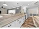 Updated kitchen features a breakfast bar with granite countertops, stainless steel appliances and white cabinets at 3242 Brushwood Ct, Clearwater, FL 33761