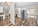 Updated kitchen offers modern stainless steel appliances, white cabinets, and wood-look flooring, connecting seamlessly with the dining area at 3242 Brushwood Ct, Clearwater, FL 33761