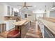 Bright kitchen with stainless appliances, island seating, wooden countertops, and wood-look flooring at 3242 Brushwood Ct, Clearwater, FL 33761