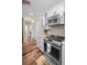 The kitchen includes modern stainless steel appliances, white cabinets, and wood-look floors, seamlessly blending style and functionality at 3242 Brushwood Ct, Clearwater, FL 33761