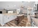This spacious open kitchen has stainless steel appliances, an island, granite countertops, and seamlessly connects to the dining area at 3242 Brushwood Ct, Clearwater, FL 33761