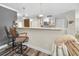 Open kitchen features a breakfast bar with seating, white cabinets, stainless steel appliances, and recessed lighting at 3242 Brushwood Ct, Clearwater, FL 33761