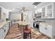 Updated kitchen features a center island, stainless steel appliances, white cabinetry, and wood-look flooring at 3242 Brushwood Ct, Clearwater, FL 33761
