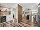 Open kitchen view with wood-look flooring, an island with stool seating, and stainless steel appliances at 3242 Brushwood Ct, Clearwater, FL 33761