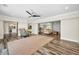 Spacious open living room with wood-look flooring and neutral color palette at 3242 Brushwood Ct, Clearwater, FL 33761