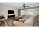 Open-concept living room showcasing wood-look flooring and sliding glass doors leading to outdoor at 3242 Brushwood Ct, Clearwater, FL 33761