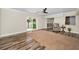 Open living room with wood-look flooring, sliding glass doors, and neutral paint at 3242 Brushwood Ct, Clearwater, FL 33761