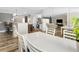 Open-concept living space features wood-look floors and a dining area that flows into the living room and kitchen at 3242 Brushwood Ct, Clearwater, FL 33761