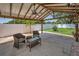 Pergola with a ceiling fan and outdoor furniture providing a comfortable outdoor space at 3242 Brushwood Ct, Clearwater, FL 33761