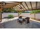 Outdoor pergola with ceiling fan, landscaping, and patio furniture, for relaxation and entertaining at 3242 Brushwood Ct, Clearwater, FL 33761