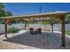 Backyard features a charming pergola, outdoor seating, and beautiful landscaping at 3242 Brushwood Ct, Clearwater, FL 33761