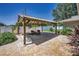 Backyard pergola with outdoor seating and lush landscaping for relaxing or entertaining at 3242 Brushwood Ct, Clearwater, FL 33761
