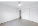 Bright bedroom featuring sleek wood floors, ceiling fan, and closet for ample storage at 3300 Haviland Ct # 103, Palm Harbor, FL 34684