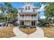 Two-story condo building featuring black stairs, white siding, and tidy landscaping, showcasing curb appeal at 3300 Haviland Ct # 103, Palm Harbor, FL 34684