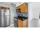 Well-appointed kitchen with stainless steel appliances, granite countertops, light wood cabinets, and tile backsplash at 3300 Haviland Ct # 103, Palm Harbor, FL 34684